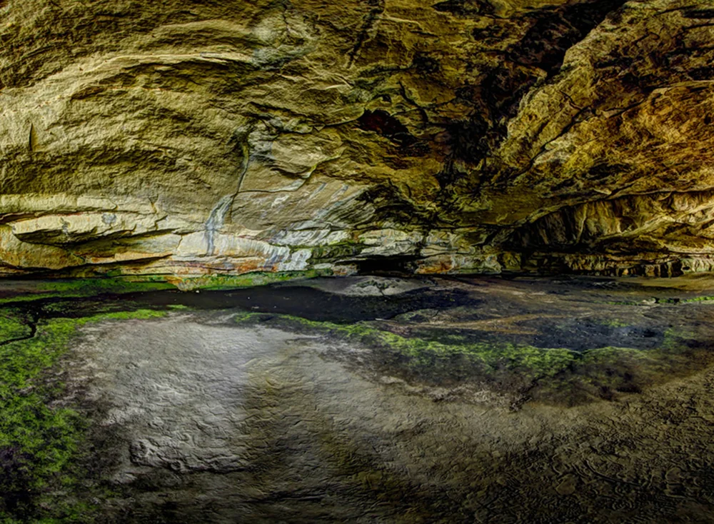 Layered sandstone and reflected light inside an Aroe Jari cavern